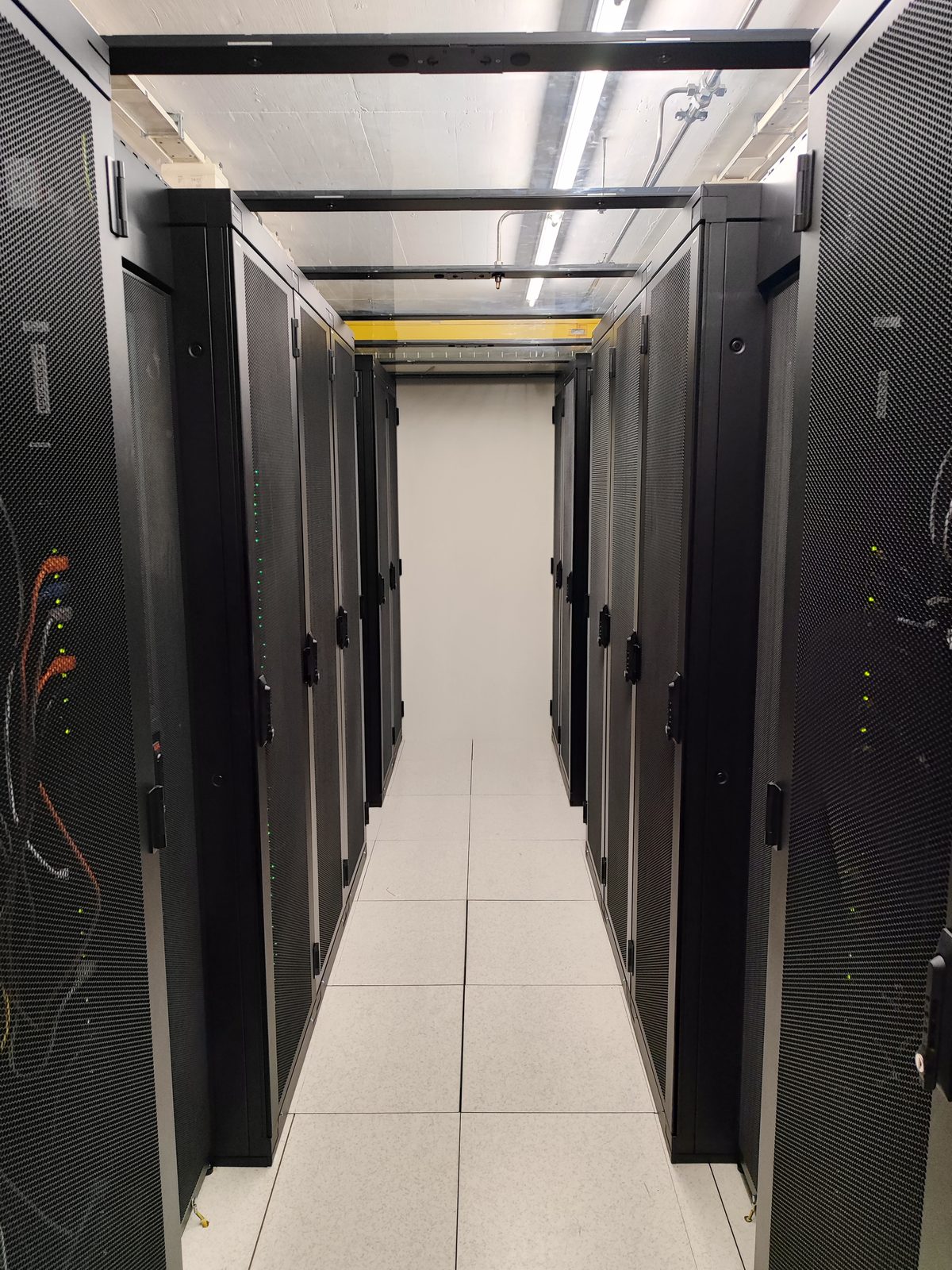 High-density rack rows in the hot corridor of AlpineDC's private suites in Crissier